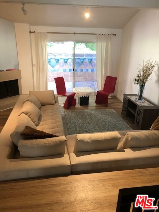 17153 Palisades Circle Pacific Palisades, CA 90272 - Photo 4 of 22 a living room with furniture and a large window