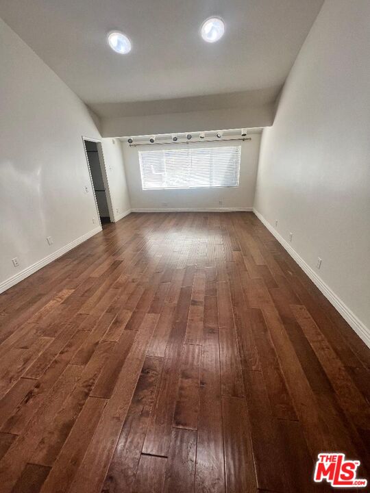 17153 Palisades Circle Pacific Palisades, CA 90272 - Photo 7 of 22 wooden floor in an empty room with a window