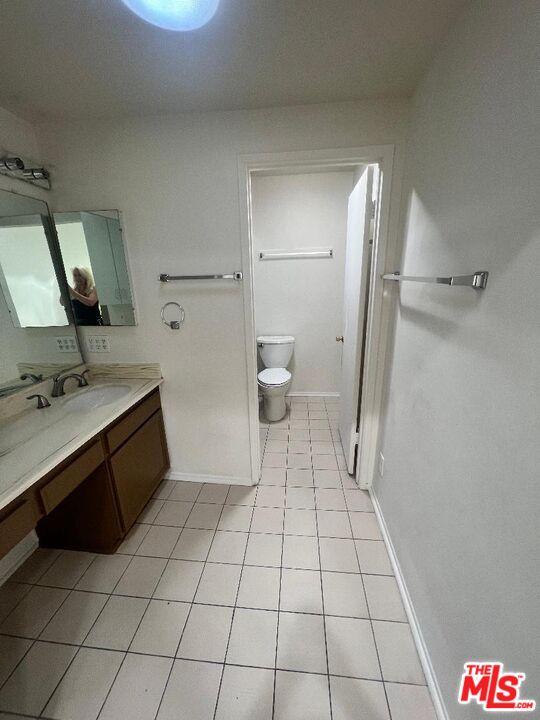 17153 Palisades Circle Pacific Palisades, CA 90272 - Photo 9 of 22 a bathroom with a sink a toilet and a mirror