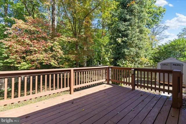 a balcony with wooden floor and fence