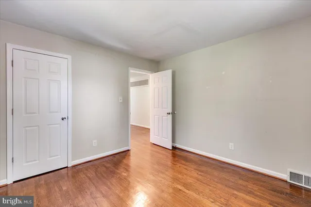 a view of an empty room and wooden floor