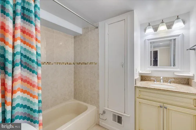 a bathroom with a tub sink and mirror