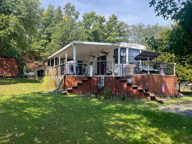 a view of a house with a yard porch and sitting area