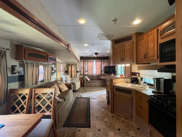 a kitchen with a refrigerator and a stove top oven