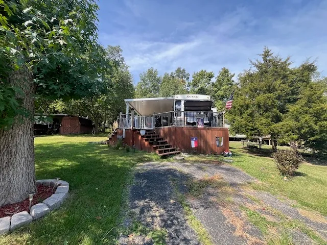 a view of a house with backyard porch and sitting area
