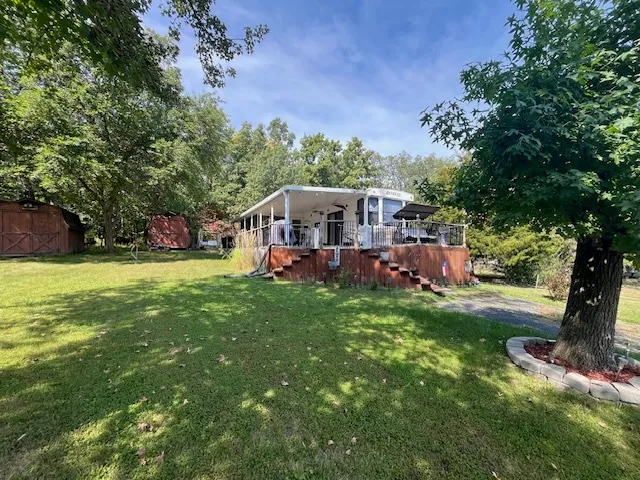 a view of a house with a yard porch and sitting area