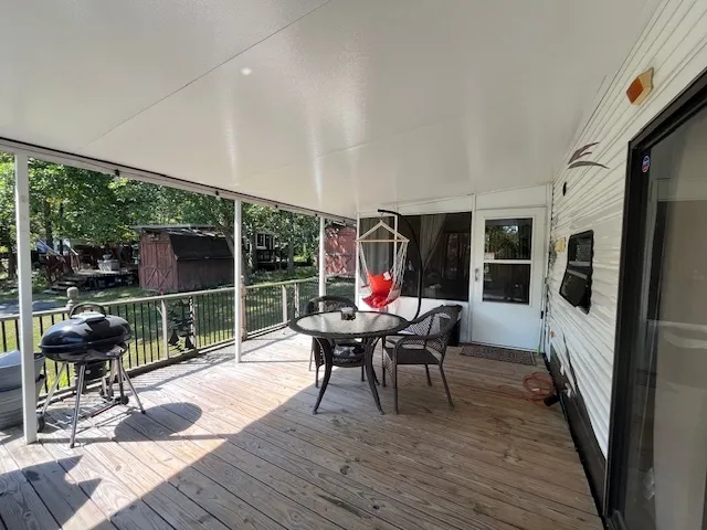 a sitting area with furniture on deck and wooden floor