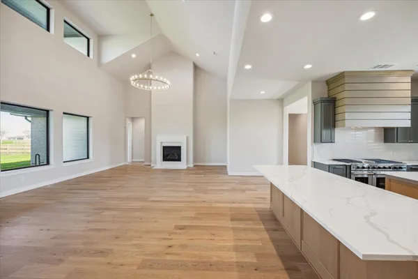 a large kitchen with kitchen island a sink stainless steel appliances and cabinets