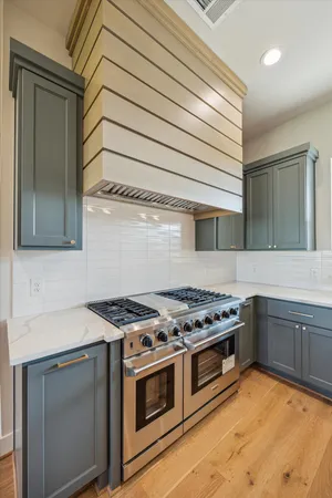 a kitchen with stainless steel appliances granite countertop a stove and a sink