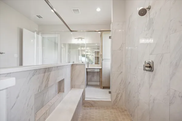 a bathroom with a shower and a sink