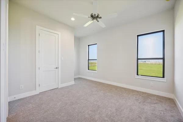 an empty room with windows and closet