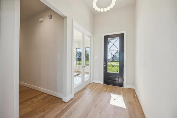 a view of an entryway with wooden floor