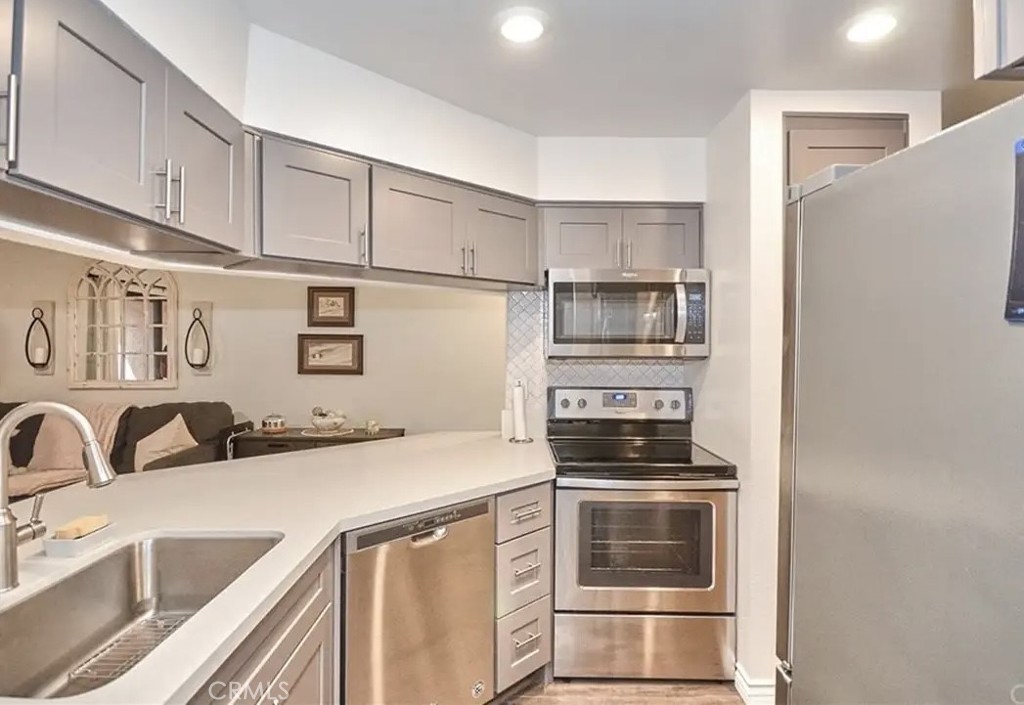 10655 Lemon Avenue, Unit 2605 Rancho Cucamonga, CA 91737 - Photo 2 of 7 a kitchen with stainless steel appliances a stove sink and cabinets