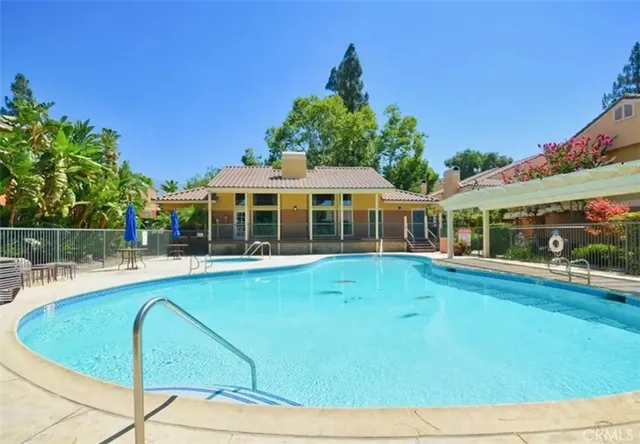 a view of a house with swimming pool and porch