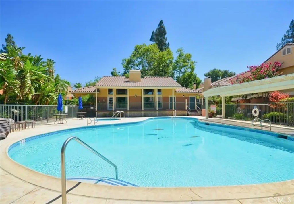 10655 Lemon Avenue, Unit 2605 Rancho Cucamonga, CA 91737 - Photo 6 of 7 a view of a house with swimming pool and porch