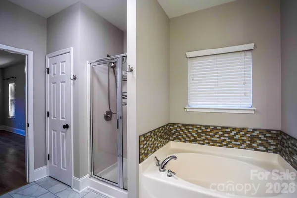 a bathroom with a bathtub and shower