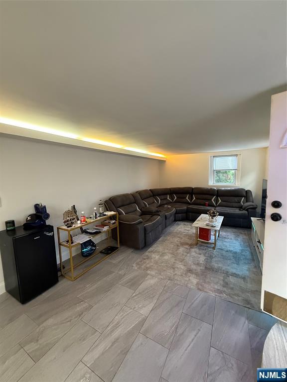 61 Sabina Street, Unit 1 Little Ferry, NJ 07643 - Photo 8 of 16 a living room with furniture and a flat screen tv