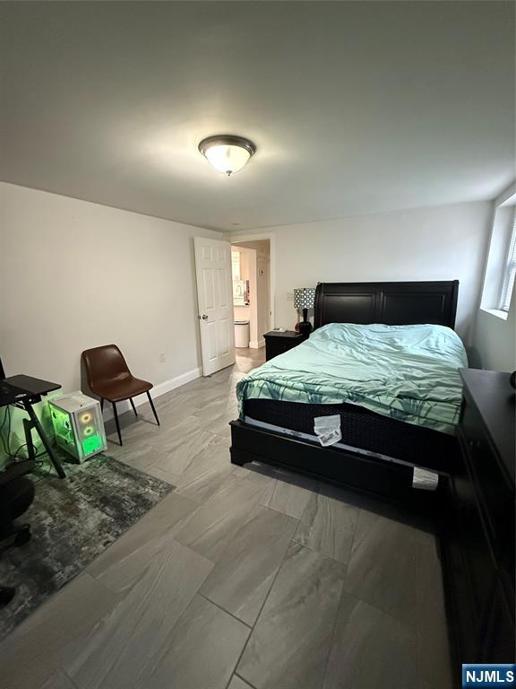 61 Sabina Street, Unit 1 Little Ferry, NJ 07643 - Photo 9 of 16 a bedroom with a bed and a chandelier