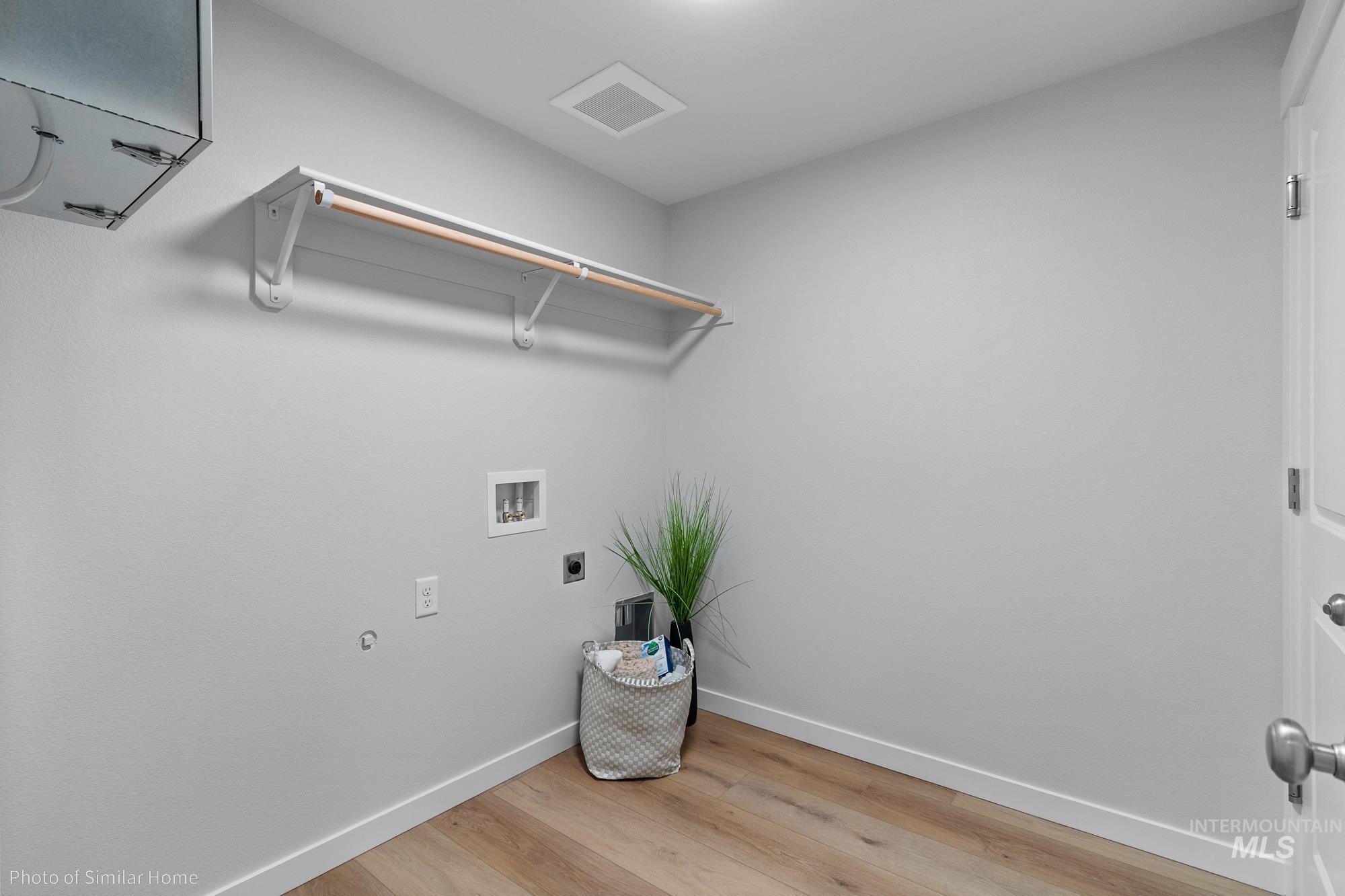 1047 Adamite Road Kimberly, ID 83341 - Photo 6 of 8 Laundry room with light wood-type flooring, hookup for an electric dryer, and washer hookup