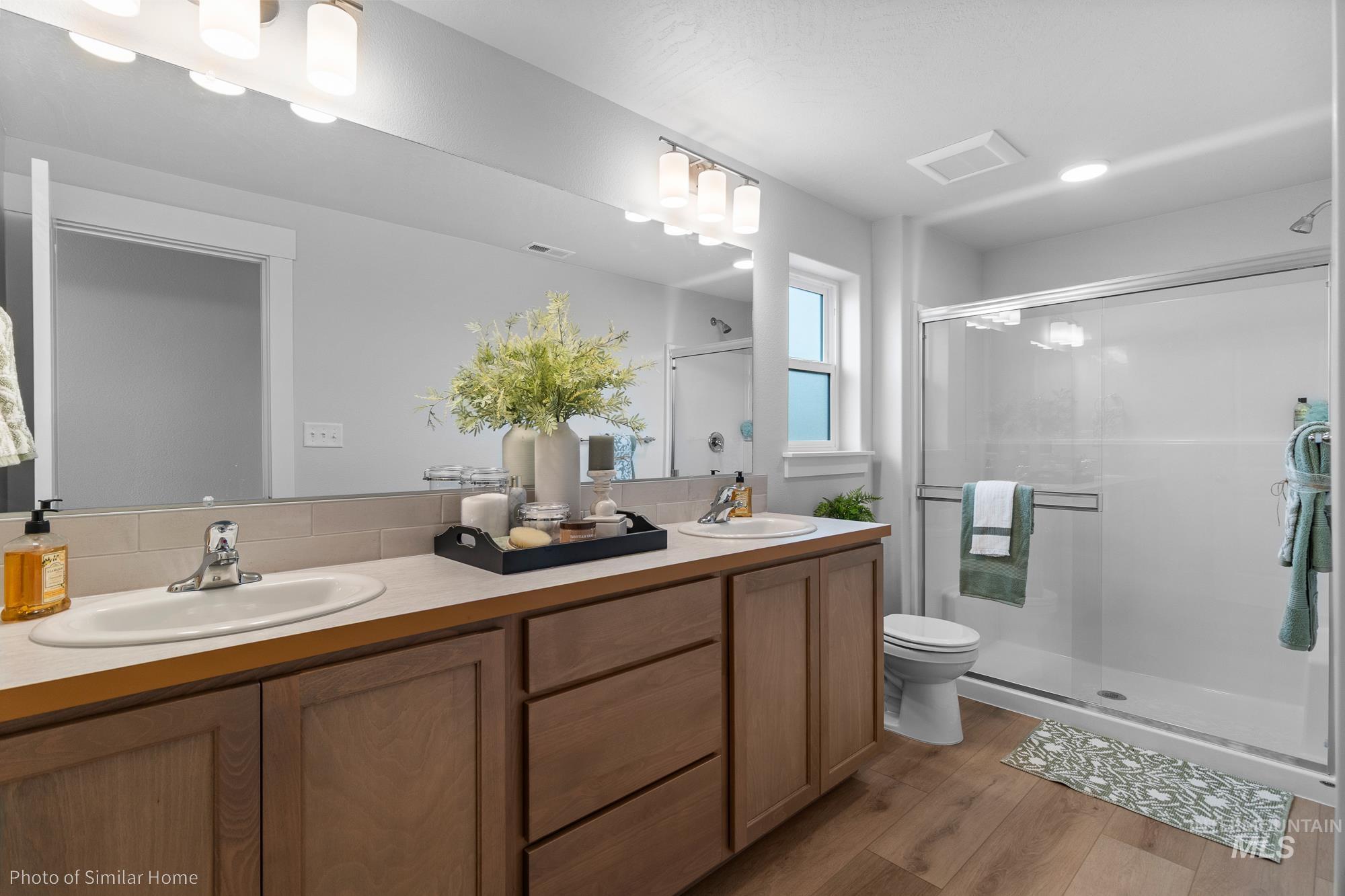 1047 Adamite Road Kimberly, ID 83341 - Photo 8 of 8 Full bathroom featuring a shower stall, double vanity, and light wood-style flooring
