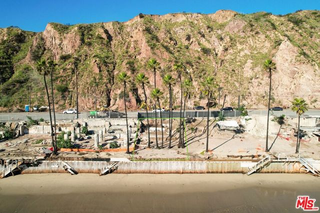 a view of a cafe with a table and chairs under an umbrella