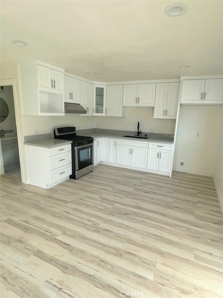 3374-unit A 3374-unit A Fashion Long Beach, CA 90810 - Photo 1 of 16 a large kitchen with stainless steel appliances wooden floor and a refrigerator