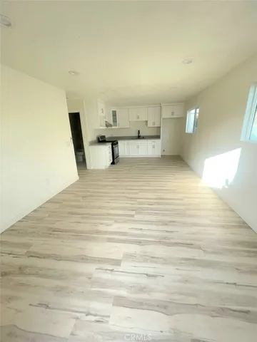 a view of kitchen and empty room