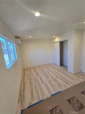 a view of a room with wooden floor and staircase