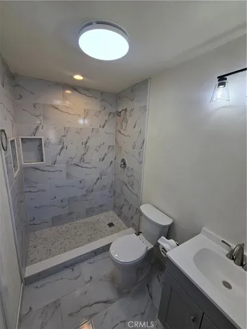 a bathroom with a toilet sink and shower