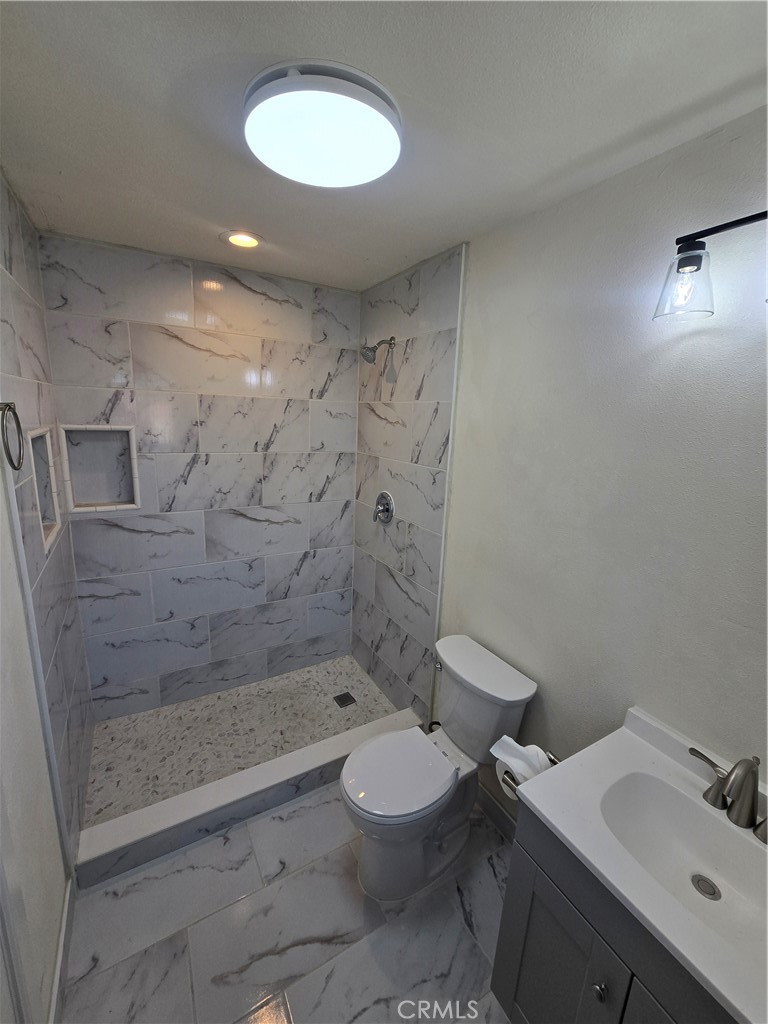 3374-unit A 3374-unit A Fashion Long Beach, CA 90810 - Photo 9 of 16 a bathroom with a toilet sink and shower