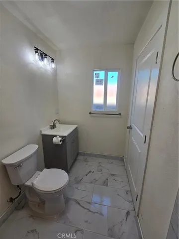 a white toilet sitting next to a bathroom sink