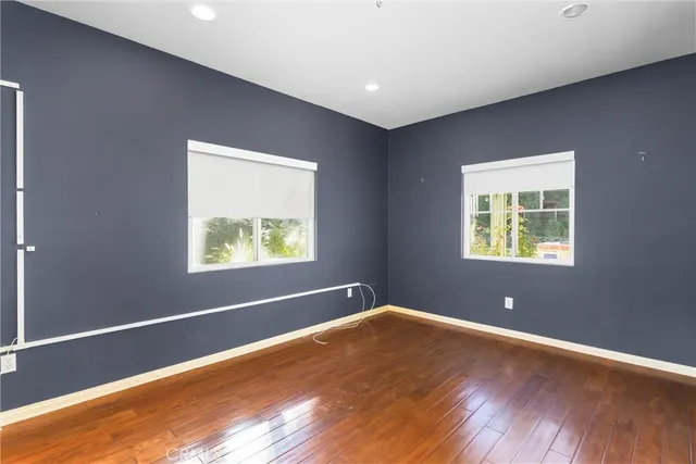 a view of a hallway with wooden floor and a chandelier