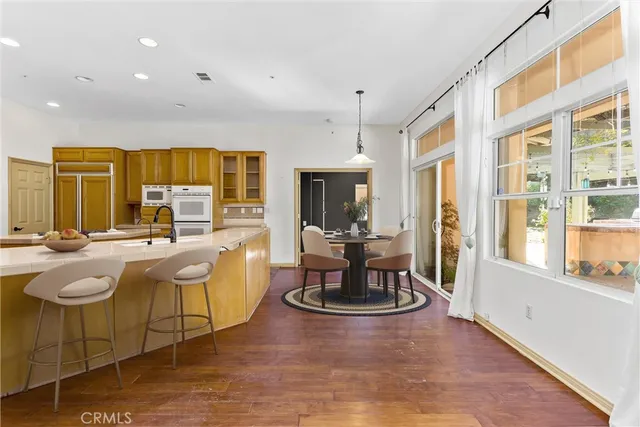 a bedroom with a large bed couch and a large window
