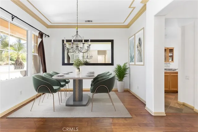a view of a house with a yard and potted plants