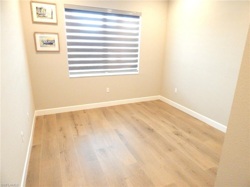 11331 Jacaranda Drive Naples, FL 34120 - Photo 14 of 47 Spare room with wood finished floors and baseboards