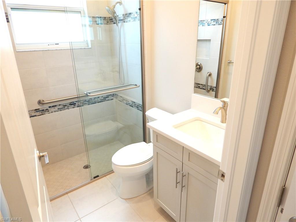 11331 Jacaranda Drive Naples, FL 34120 - Photo 15 of 47 Bathroom with toilet, a stall shower, vanity, and tile patterned floors