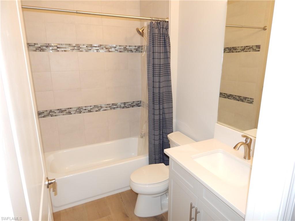 11331 Jacaranda Drive Naples, FL 34120 - Photo 31 of 47 Bathroom with toilet, vanity, and shower / bath combo