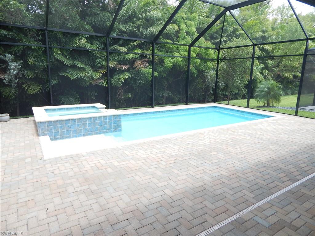 11331 Jacaranda Drive Naples, FL 34120 - Photo 4 of 47 View of pool with a lanai, a patio, and a pool with connected hot tub