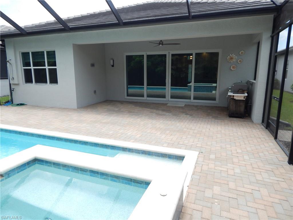 11331 Jacaranda Drive Naples, FL 34120 - Photo 5 of 47 Swimming pool with a patio area, a ceiling fan, area for grilling, and a lanai