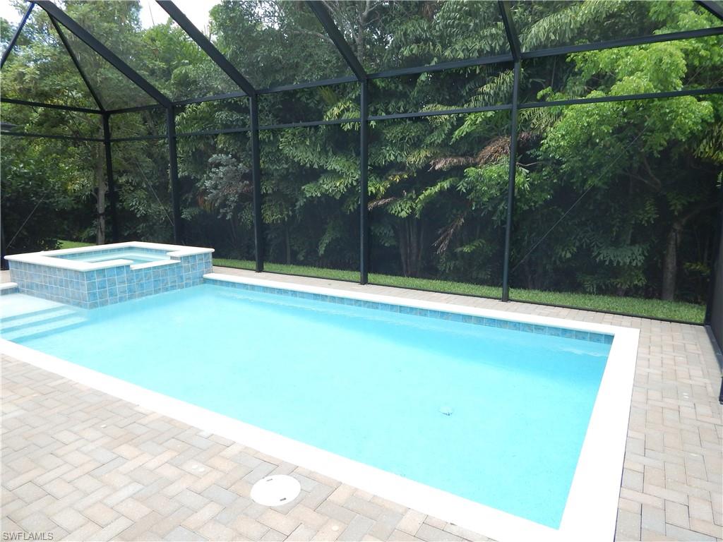 11331 Jacaranda Drive Naples, FL 34120 - Photo 6 of 47 View of pool featuring a pool with connected hot tub and glass enclosure