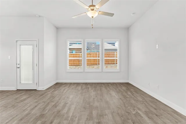 wooden floor in an empty room with a window
