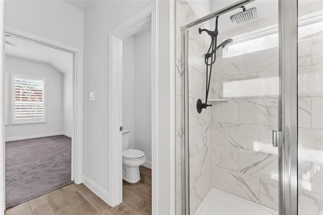 a bathroom with a granite countertop shower