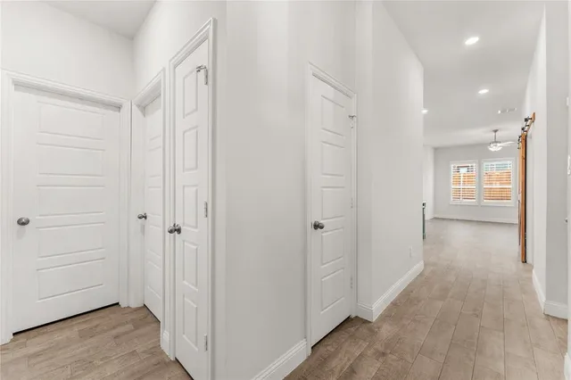 a view of a hallway with wooden floor