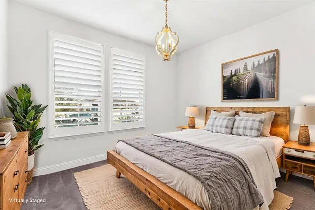 a spacious bedroom with a bed and a window