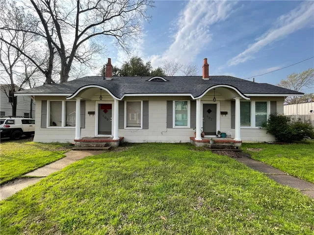 a front view of a house with patio and garden