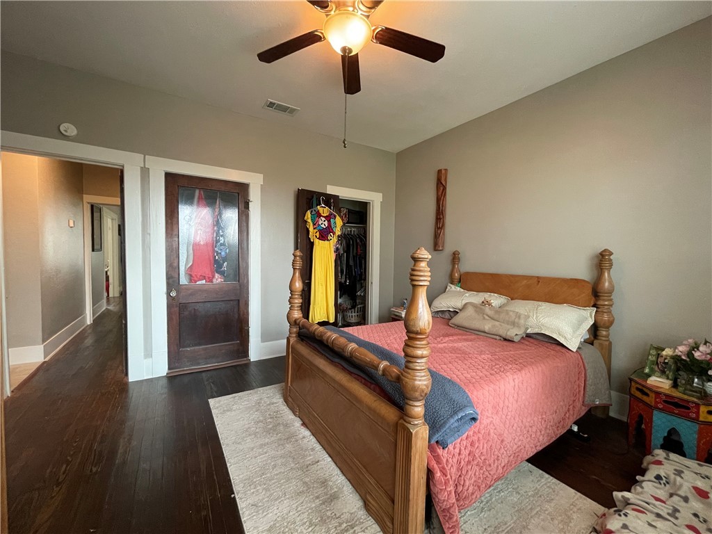 407 East Pease Street Bryan, TX 77803 - Photo 12 of 14 a bed room with a bed and a chandelier