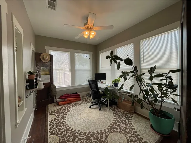 a living room with furniture a chandelier and a window