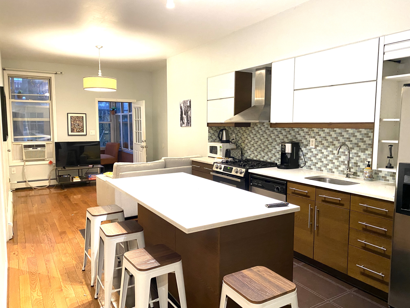 a kitchen with a table chairs sink and cabinets
