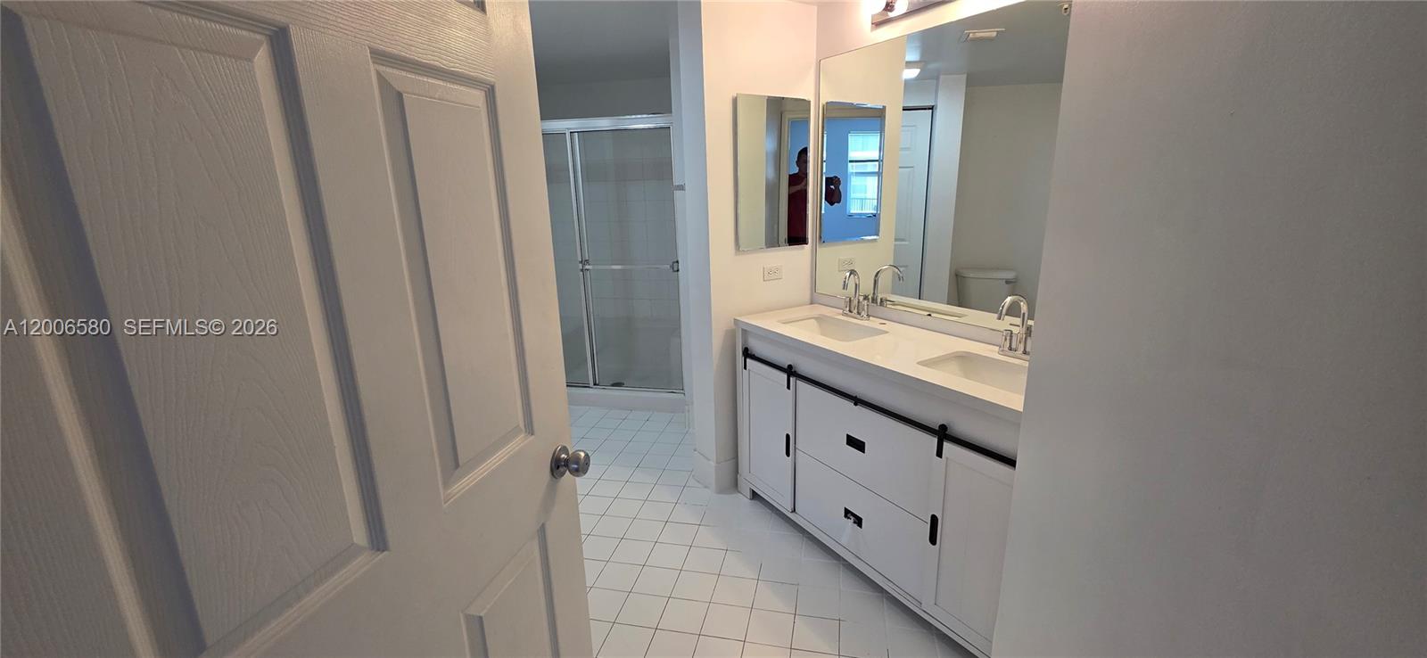 17150 North Bay Road, Unit 2602 Sunny Isles Beach, FL 33160 - Photo 22 of 27 a bathroom with a granite countertop sink and a mirror