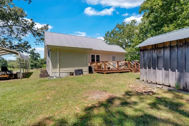 a view of a house with backyard and sitting area